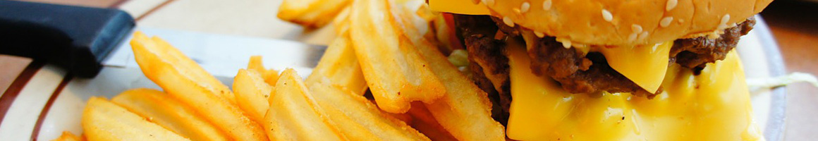 Eating American (Traditional) Burger at Kill Devil's Frozen Custard & Beach Fries restaurant in Kill Devil Hills, NC.